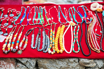 The red handmade table with the Souvenirs from Tibet in the mountain village in Nepal.