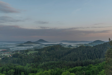 View from Jehla hill over Ceska Kamenice town in spring misty morning