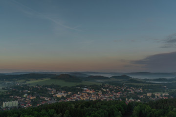 Fototapeta na wymiar View from Jehla hill over Ceska Kamenice town in spring misty morning