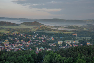 View from Jehla hill over Ceska Kamenice town in spring misty morning