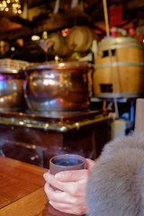 Pots of mulled wine in a stall in a Christmas market.