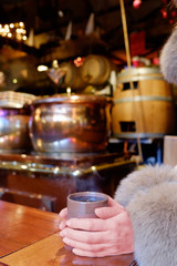 Pots of mulled wine in a stall in a Christmas market.