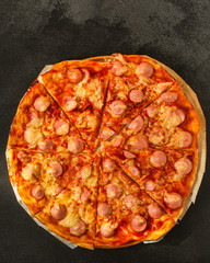 pizza with sausages (tomato sauce, cheese, meat). food background. top view. copy space