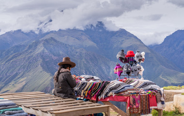 Peruvian women selling colorful hats and scarfs on the scenic and popular viewpoint.