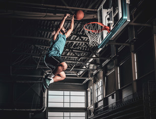 Black professional Black basketball player in action in a basketball court.