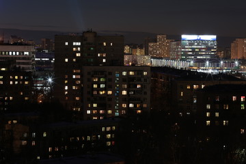 Fototapeta na wymiar Residential buildings with luminous windows in a residential area in Moscow at night
