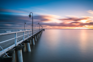 Wooden pier in Gdynia Orlowo in the morning with colors of sunrise. Poland. Europe. - obrazy, fototapety, plakaty