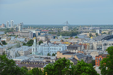 Fototapeta na wymiar Kyiv cityscape with the Dnipro river. View on Podil district