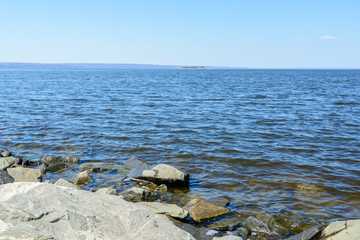 View of the Volga River from the Presidential Bridge in the city of Ulyanovsk. The widest place on the Volga River. Island on the Volga River. Sunny day.