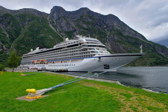 EIDFJORD, NORWAY - August 2018: Cruise ship sol in port of Eidfjord with nice view on the mountains in the Fjord with cloudy horizon