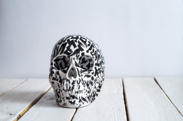 skull on the white wall and wood background