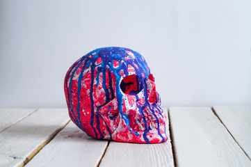 skull on the white wall and wood background