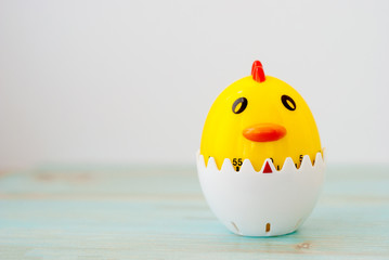 Kitchen timer rooster shaped on wooden background