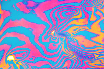 Abstract trendy neon colored psychedelic fluorescent striped zebra textured background.