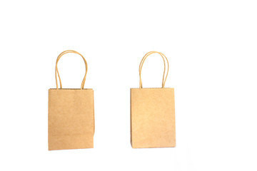 two brown paper shopping bags with hands isolated on white background