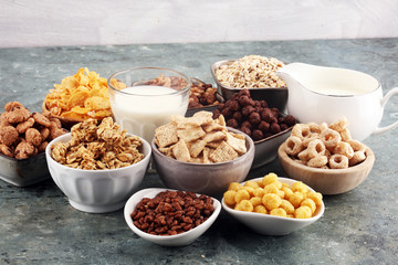 Cereal. Bowls of various cereals and milk for breakfast. Muesli with kids cereals.