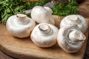 Fresh mushrooms on cutting board.