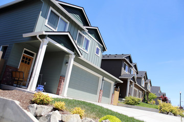 Modern homes lined up in a row on a sunny day.