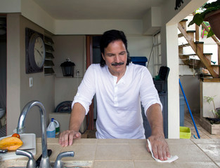 Hispanic man cleaning counter top with paper towel - 272884015