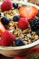 Cereal. Bowl of granola cereals, fruits and milk for breakfast. Muesli with cereals.