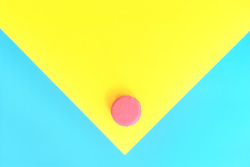 Macaroon in watercolor style on yellow-blue background. Abstract geometric pattern. Watercolor style. Minimal food concept. Colorful design. 