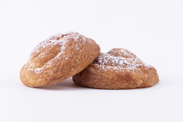 A couple of freshly baked puff pastries with powdered sugar on top