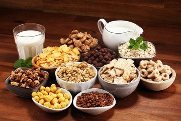 Cereal. Bowls of various cereals and milk for breakfast. Muesli with kids cereals.
