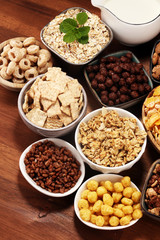 Cereal. Bowls of various cereals and milk for breakfast. Muesli with kids cereals.