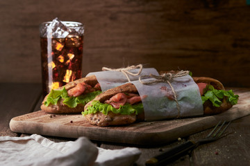 Tasty salmon sandwich with salad
