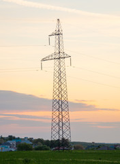 high voltage towers against sunrise
