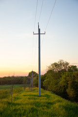 Fototapeta na wymiar high voltage towers against sunrise