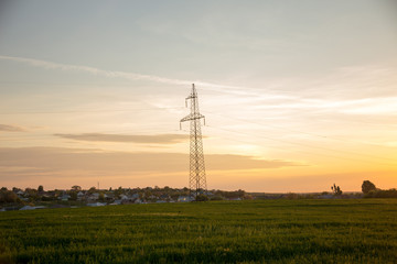 high voltage towers against sunrise