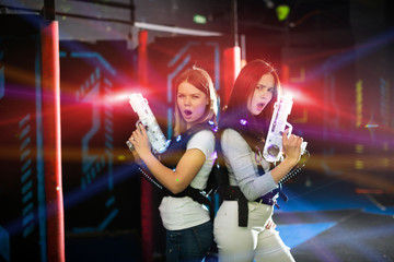 Girls back to back in colorful laser beams