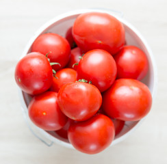 on the table fresh tomatoes from the garden on a white bucket