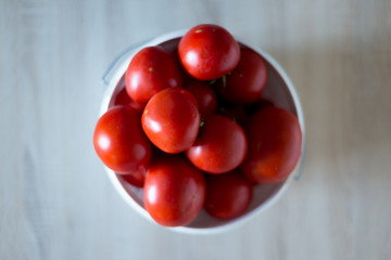 on the table fresh tomatoes from the garden on a white bucket