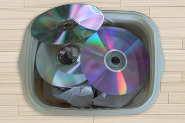 Obsolete concept: CD, DVD in the trash being discarded. Technological evolution. Electronic waste...