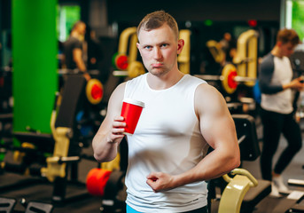 Fototapeta na wymiar Young man drink coffee after exercise