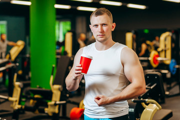 Fototapeta na wymiar Young man drink coffee after exercise