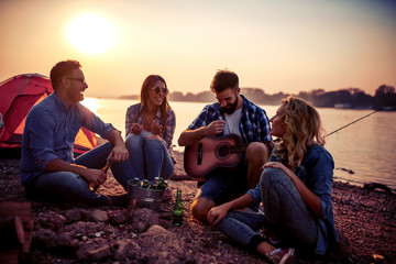 Group of friends have fun on camping