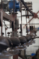 Fototapeta premium Line for painting iron door handles, hanging on hooks.