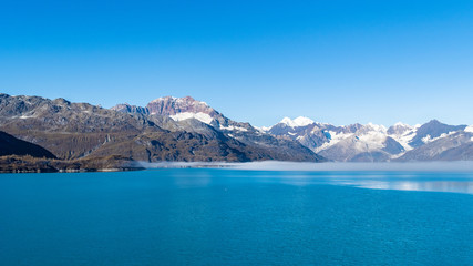 Naklejka premium Glacier Bay National Park, Alaska. Spectacular sweeping vista of ice capped/ snow covered mountains, glaciers, wildlife landscape. Absolutely breathtaking natural untouched serene nature views.