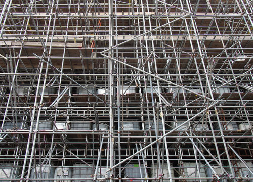 scaffolding on a construction siteshowing ibc water filled intermediate bulk containers used as ballast on each level