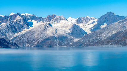 Fototapeta na wymiar Glacier Bay National Park, Alaska. Spectacular sweeping vista of ice capped/ snow covered mountains, glaciers, wildlife landscape. Absolutely breathtaking natural untouched serene nature views.
