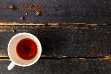 Empty coffee cup on wooden table with space for text. Composition for coffee shop and coffee making.