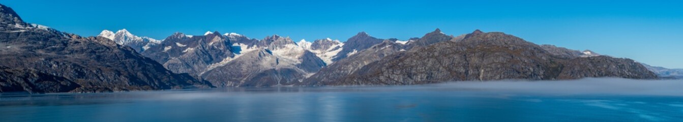 Fototapeta na wymiar Glacier Bay National Park, Alaska. Spectacular panorama sweeping vista of ice capped/ snow covered landscape of mountains, glaciers, wildlife. Breathtaking view of natural untouched serene nature.