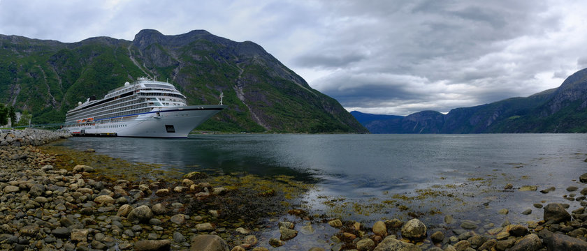 EIDFJORD, NORWAY - August 2018: Cruise ship sol in port of Eidfjord with nice view on the mountains in the Fjord with cloudy horizon