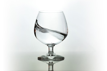 Water spray in wineglass. Water splash.