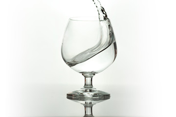 Water spray in wineglass. Water splash.