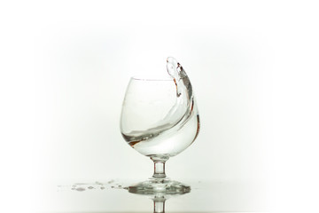 Water spray in wineglass. Water splash.