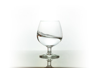 Water spray in wineglass. Water splash.